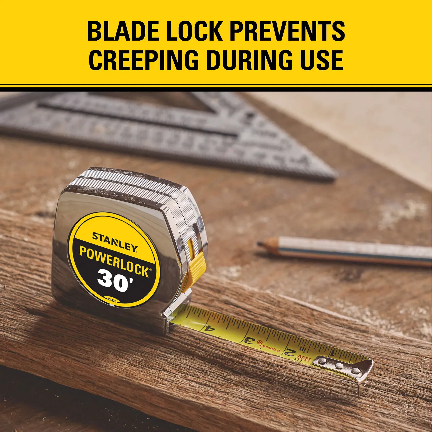 A Stanley PowerLock 30-foot tape measure with a blade lock is shown on a piece of wood, with a pencil and square tool in the background. The text reads: 'Blade lock prevents creeping during use.'