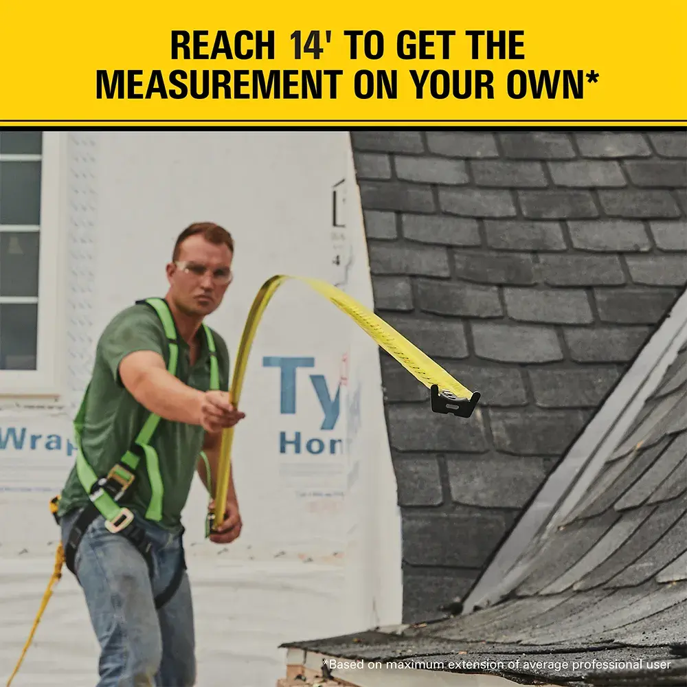 A construction worker using a yellow STANLEY tape measure, extending it across a roof to a length of 14 feet. The text above reads 'REACH 14' TO GET THE MEASUREMENT ON YOUR OWN*'. The worker's face is blurred.