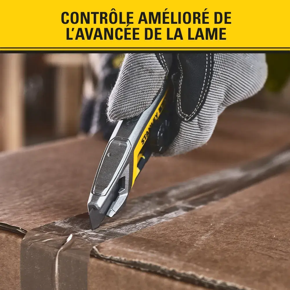 Photo of STANLEY FMHT10592-0 utility knife cutting cardboard, detailed side view in use.