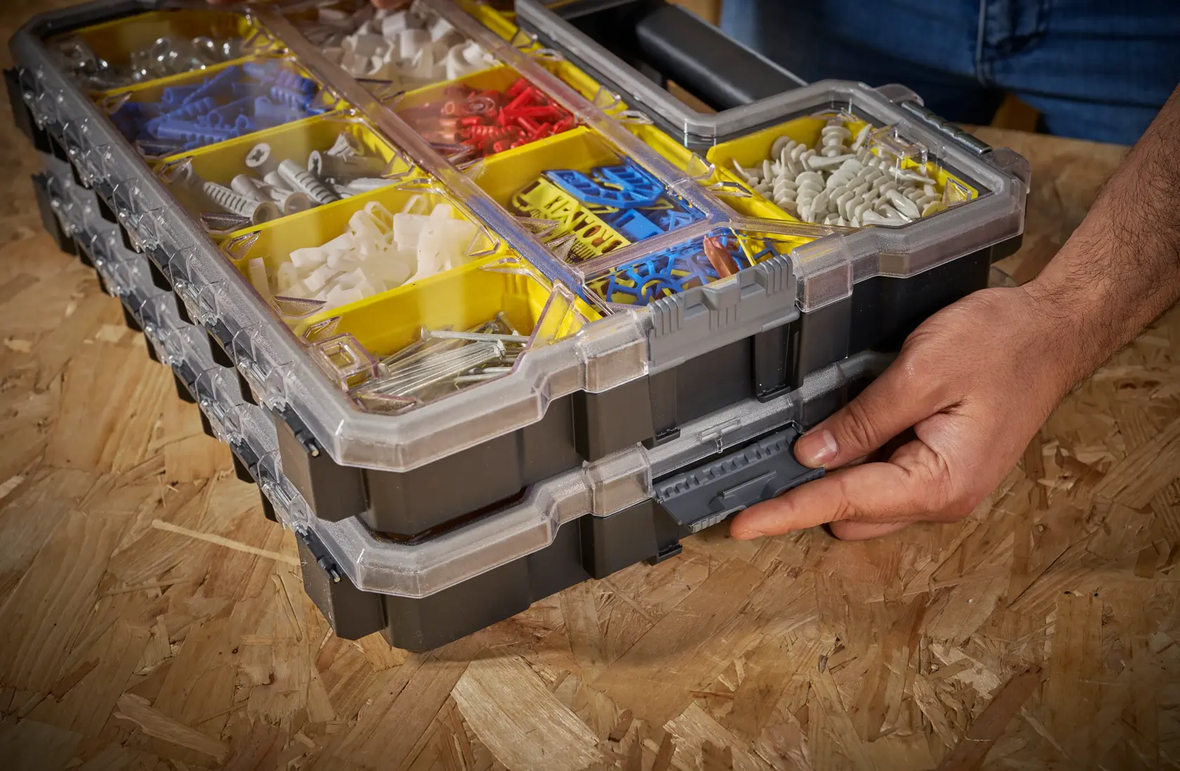 STANLEY FMST14820 organizer box with yellow compartments, clear lid, and assorted fasteners, hand unlatching front clip.