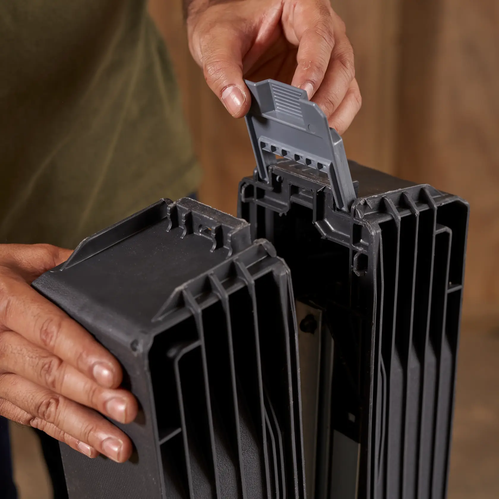STANLEY STST11151 black plastic part with hand unlocking latch, product photography close-up.