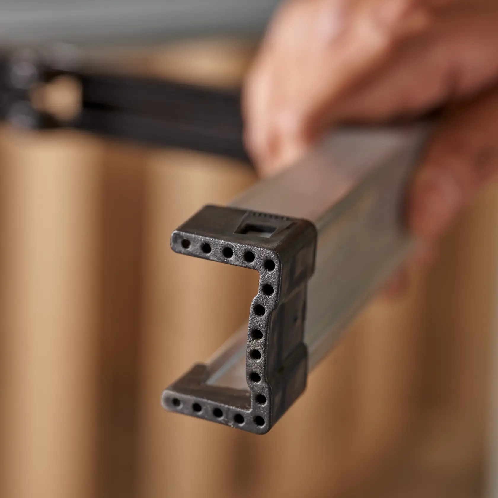 STANLEY STST11151 storage rack bar photography showing black plastic end with multiple holes.