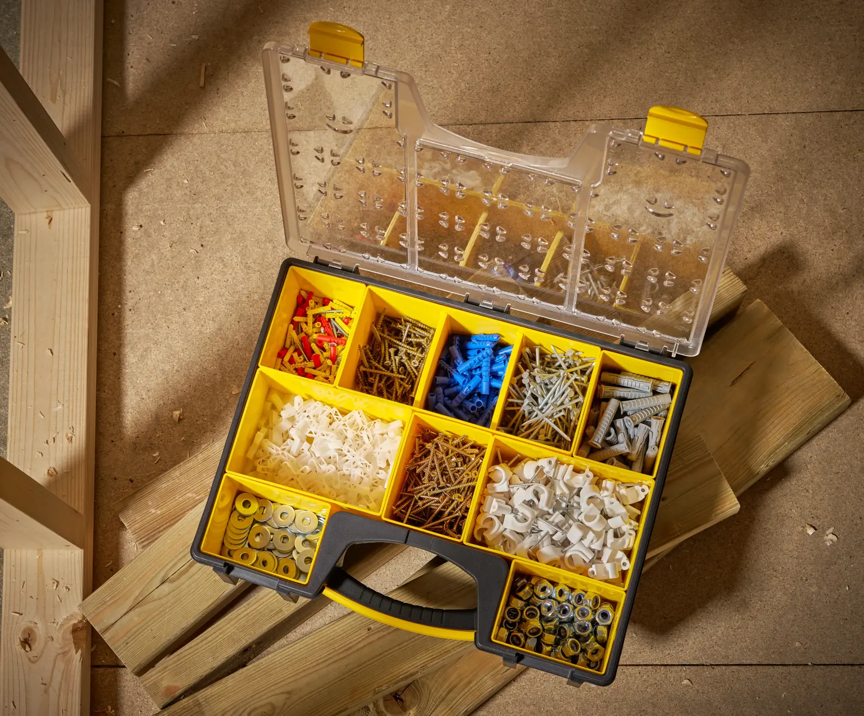 STANLEY STST14710 organizer box with yellow compartments filled with assorted fasteners, top view.