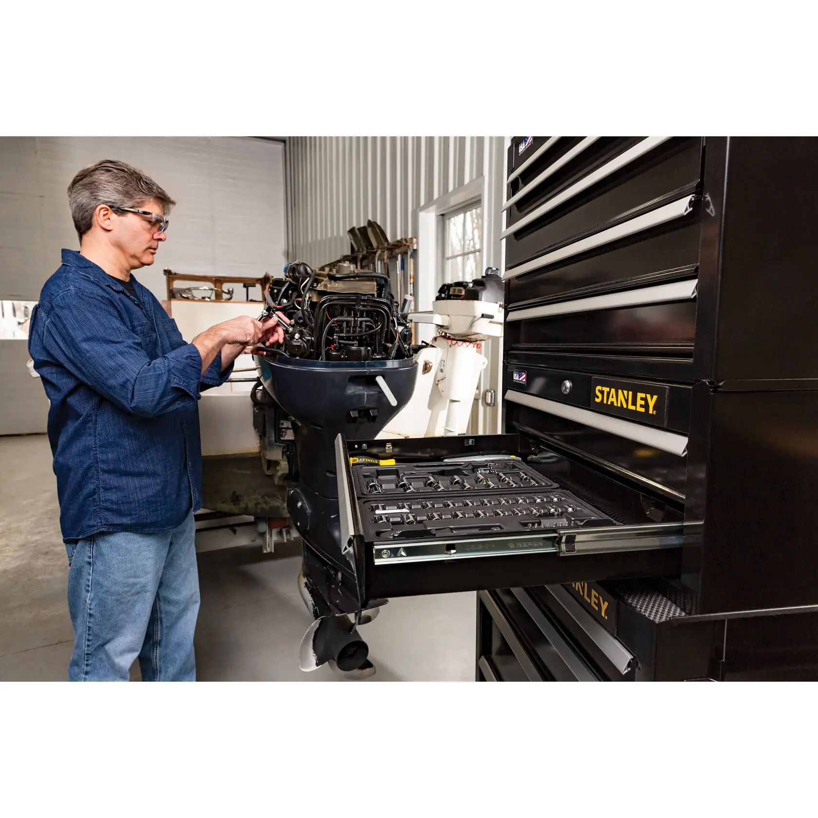 STANLEY STST22625BK tool chest with open drawer, black finish, workshop setting, side angle.