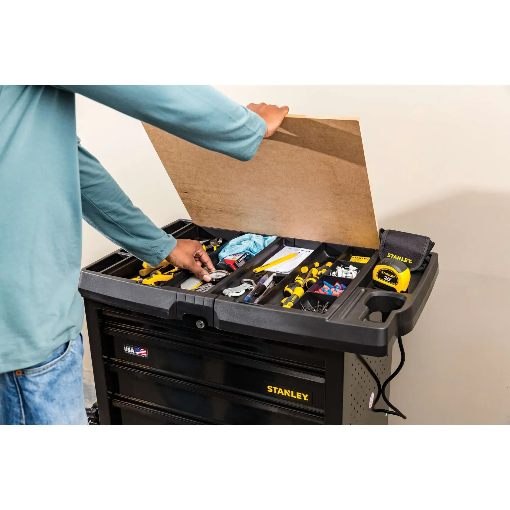 Photo of STANLEY STST23151BK tool chest with open lid, top tray organized with tools, screws, and accessories.