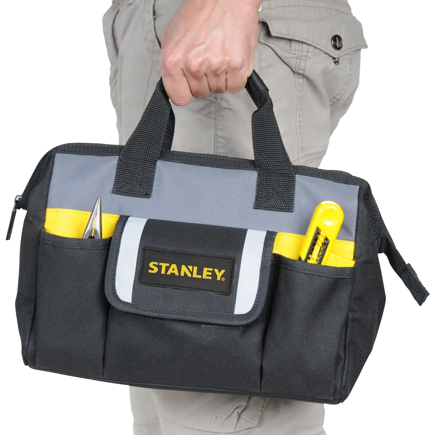 Stanley STST70574 tool bag in black and grey with yellow accents, handheld, front view.